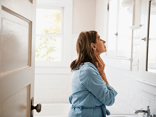 Woman checking thyroid