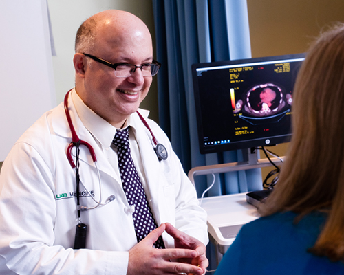 Dr. Luciano Costa, MD, PhD (Associate Professor, Hematology and Oncology) is talking with a female patient in the Comprehensive Cancer Center, 2019.