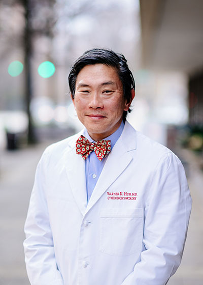 Environmental headshot of Dr. Warner Huh, MD (Professor/Chairman, Obstetrics and Gynecology) in a white medical coat, January 2021.