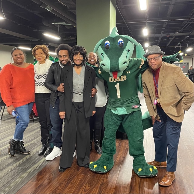 Cancer Patient Survivor Lonon celebrating her victory over cancer with Blaze at UAB's basketball game on Dec. 4