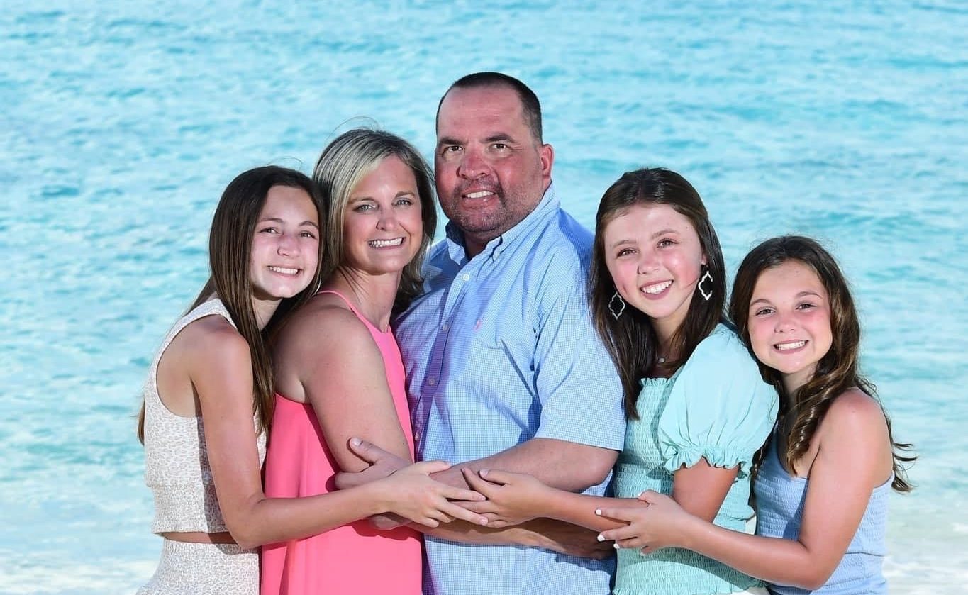Lombardo family picture posing on the beach