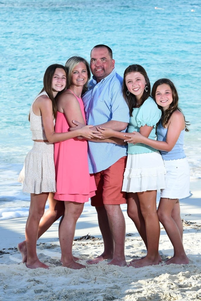 Lombardo family picture posing on the beach