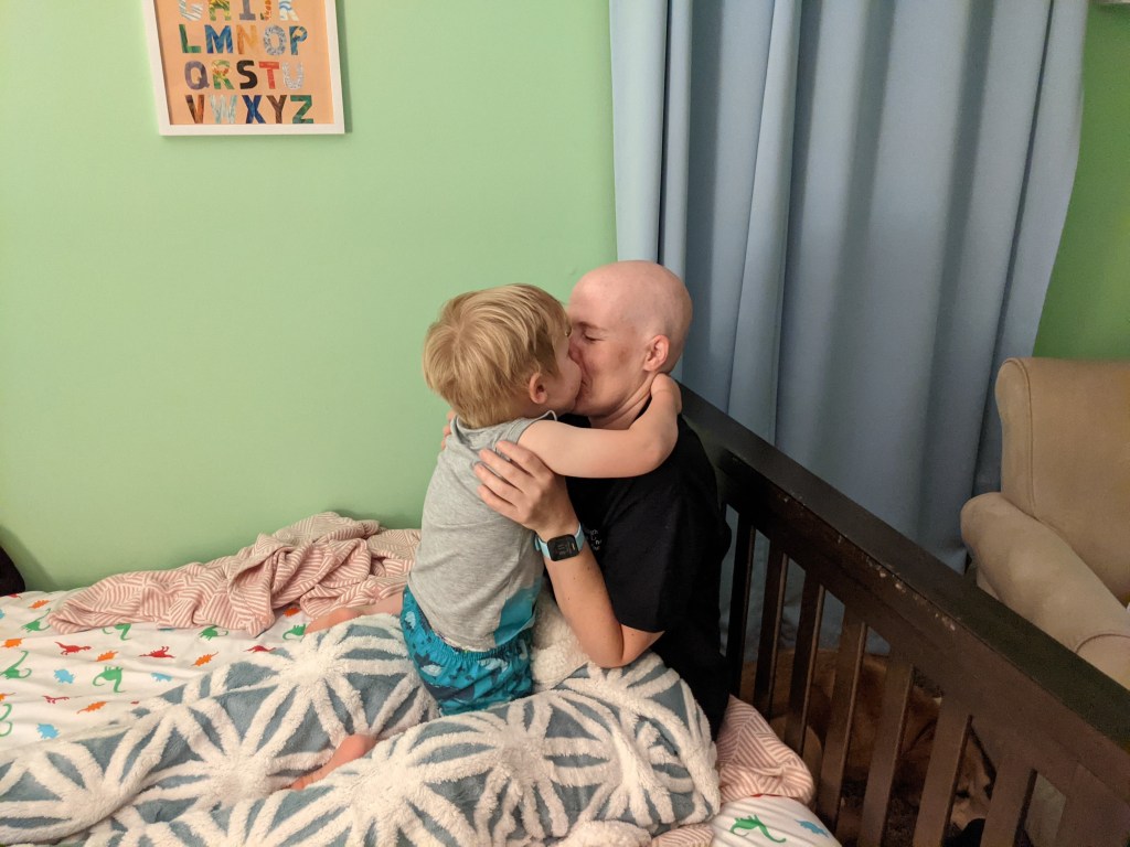 Kelly Klehm and son embrace after head shaving party