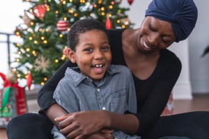 A beautiful African American mother with cancer and her son celebrate Christmas Day together