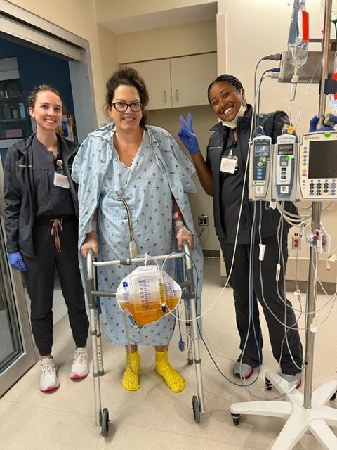 Amy Linville in a medical facility with two nurses