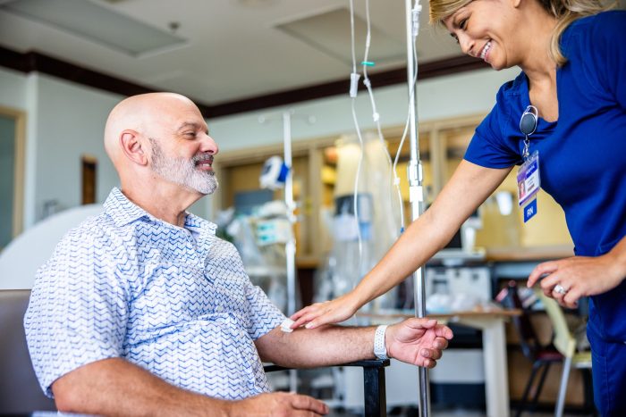 Mature Hispanic Male receiving Chemotherapy treatment in medical facility