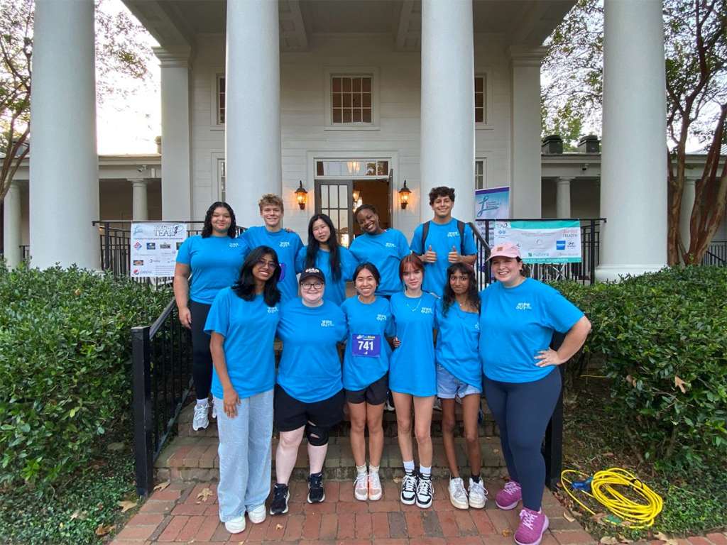 UAB experts, medical students and undergraduate students standing outside for a group photo to raise awareness of cervical cancer.