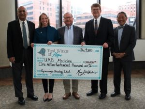 Members of Teal Wings of Hope and UAB Medicine holding a check that Teal Wings of Hope is presenting to UAB Medicine's Gynecologic Oncology Department for $1,200,000