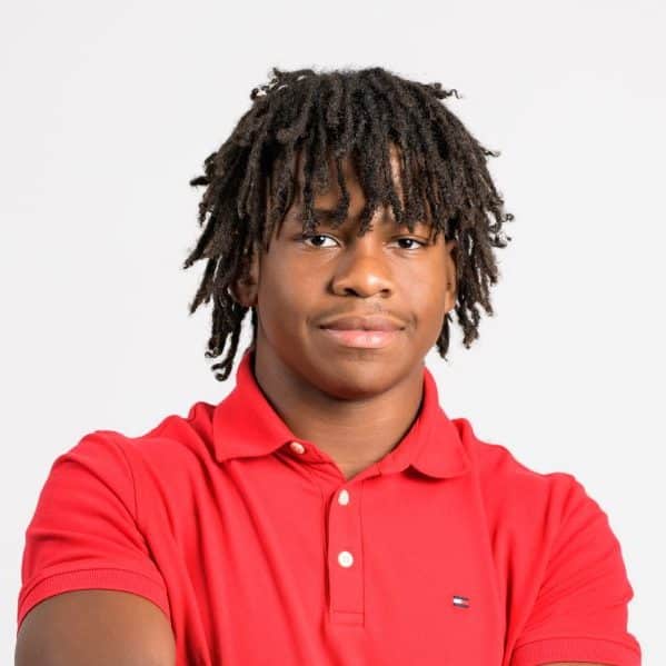 A Black high school student – Trevor Moultrie – in a red polo shirt.