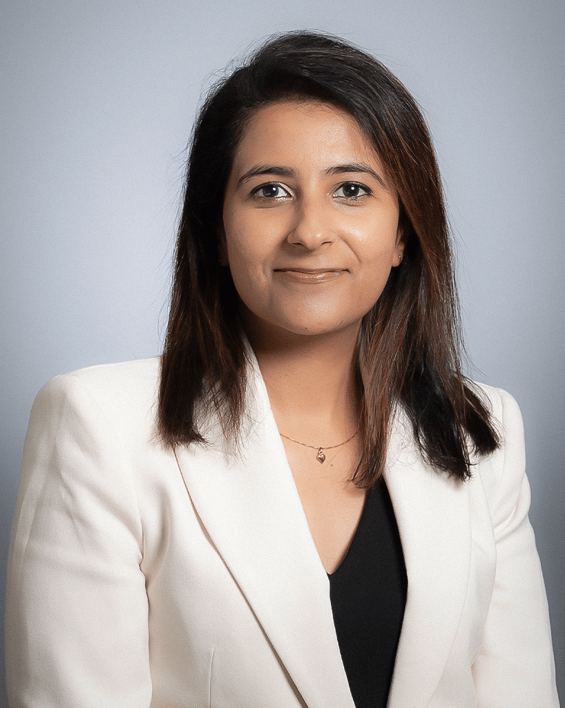 A headshot of a doctor in a black shirt and an off-white blazer; Humaira Sarfraz, M.D., MBBS.