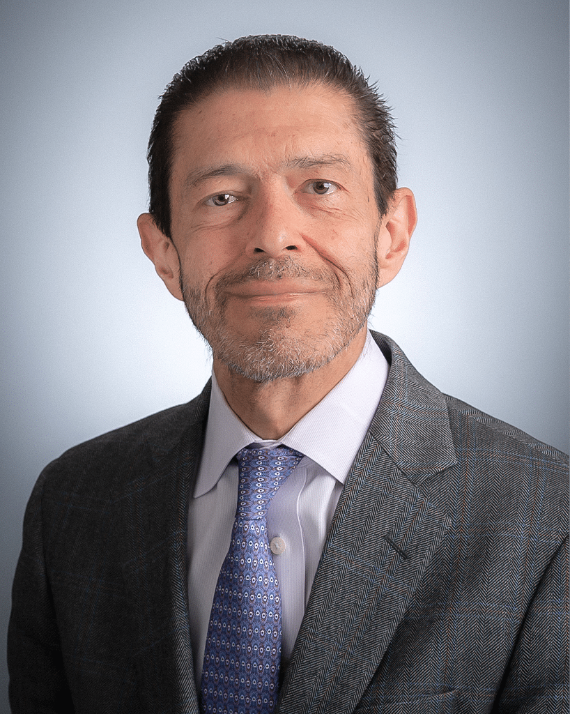 A headshot of a doctor in a gray suit and blue, decorative tie; Jorge Cortes, M.D.