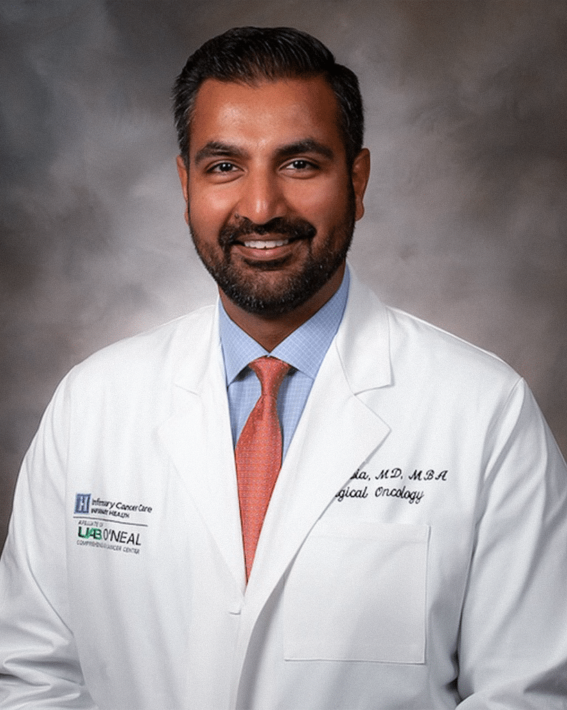 A doctor in a white lab coat and orange tie; Udai Sibia, M.D., MBA.