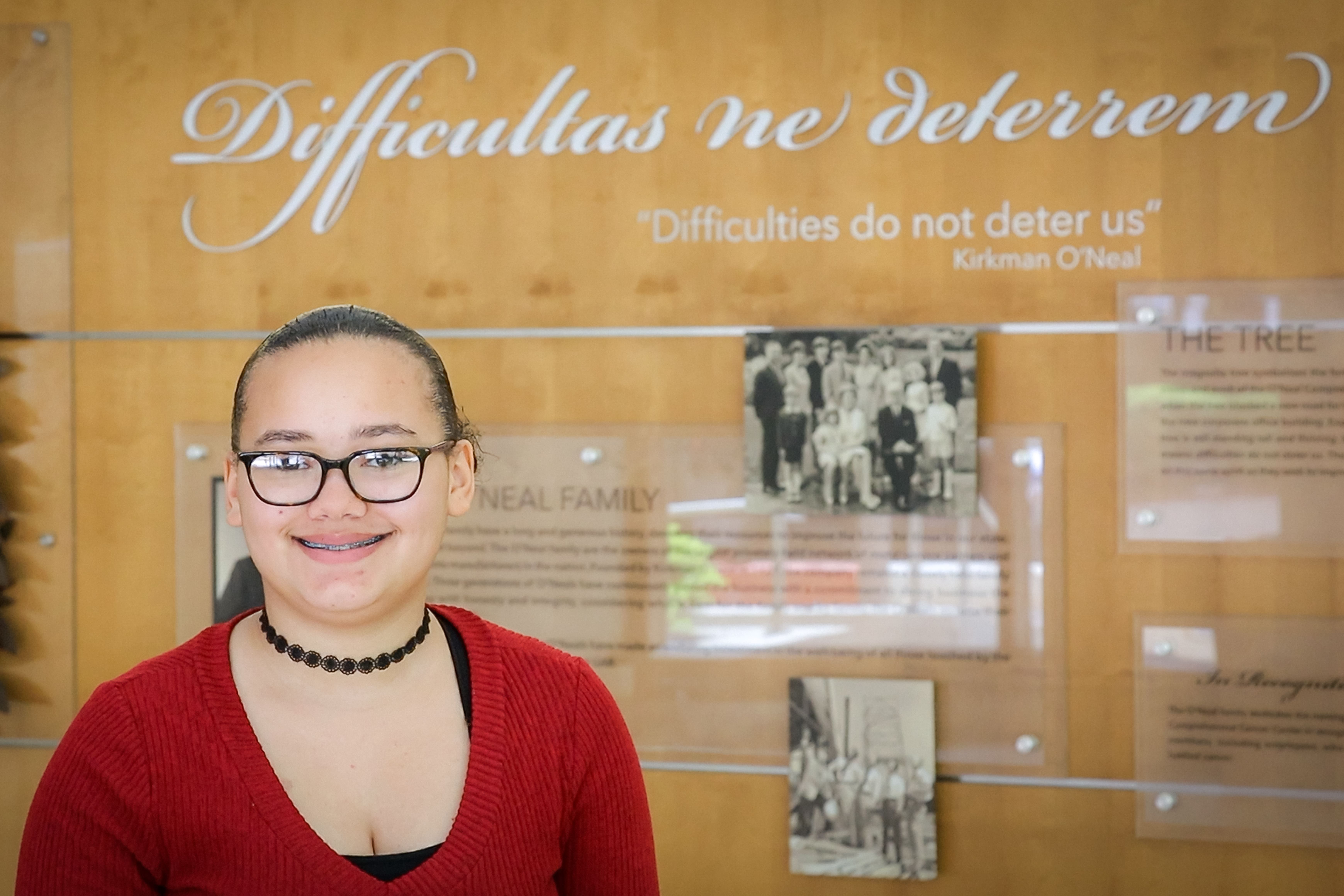 Iron Strong honoree Gabby McCraw standing in the WTI lobby.