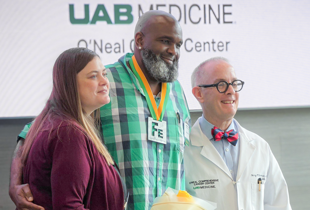 Gregory Walker standing alongside Kelly Godby, M.D., and O'Neal Cancer Center director Barry Sleckman, M.D., Ph.D. at the 2026 Iron Strong Awards.