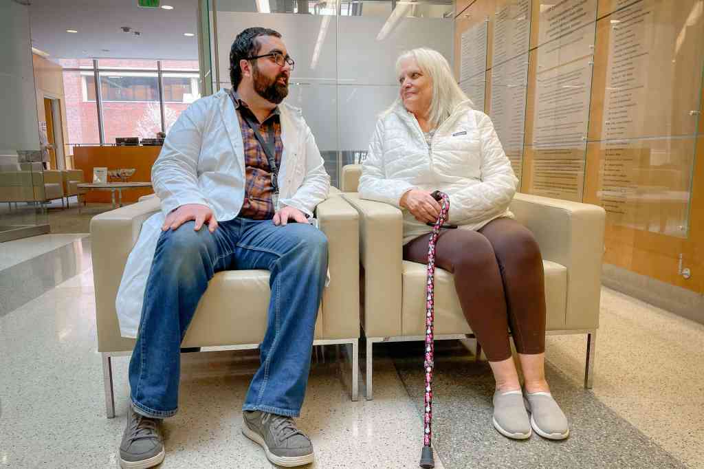 Randi Cummings, a 2026 Iron Strong awardee, sitting and talking with her son-in-law, Billy Marsiglia, Ph.D.