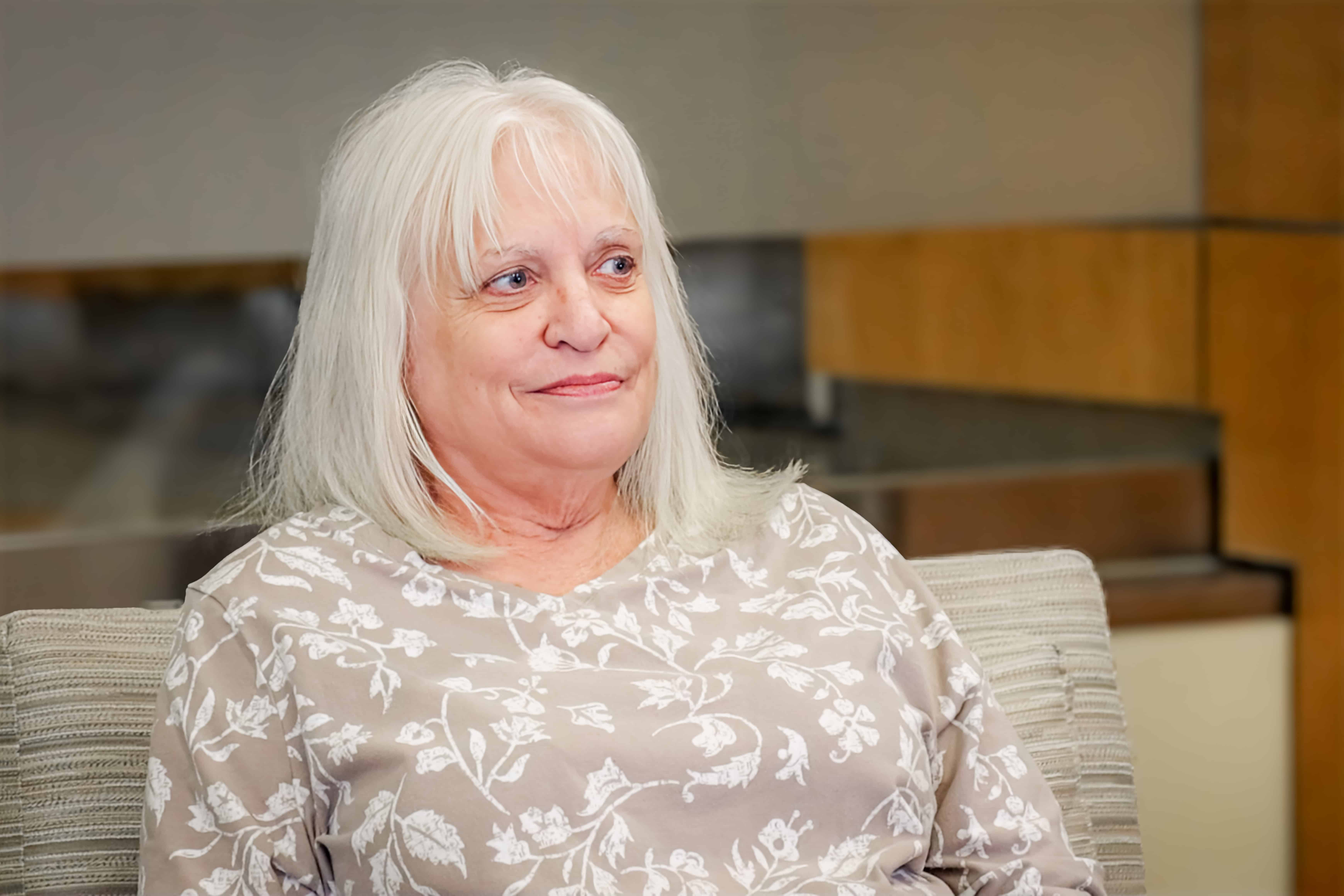 Randi Cummings, a 2026 Iron Strong honoree, sits in a room in WTI, smiling to someone off-camera.