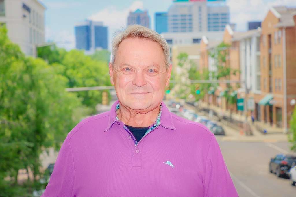 Iron Strong honoree Virgil Lugar standing against the backdrop of the city of Birmingham.