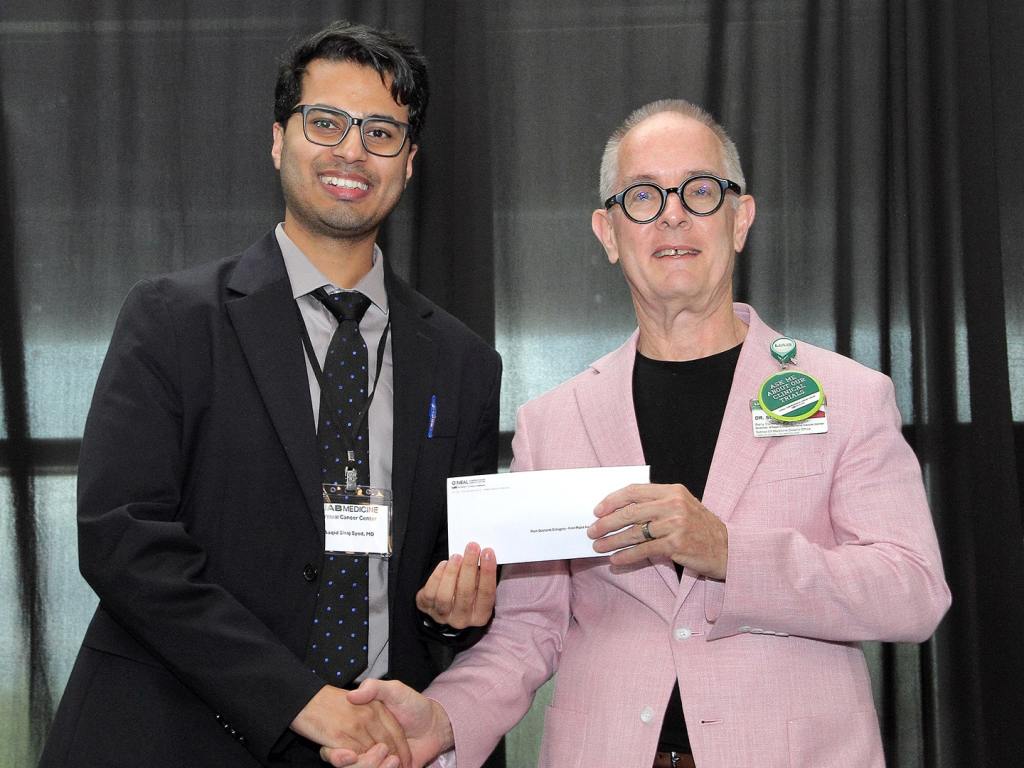 Aaquid Siraj Syed, M.D., of Mobile Infirmary receives an award at the 2026 O'Neal Research Retreat.