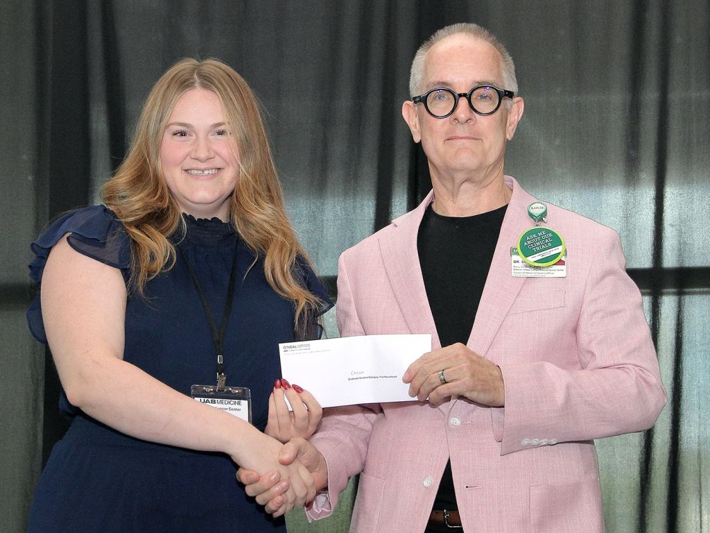 Chloe La Prairie receives an award at the 2026 O'Neal Research Retreat.