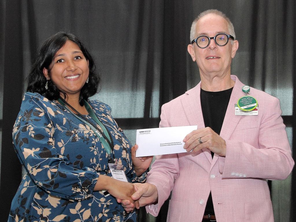 Divya Sahu receives an award at the 2026 O'Neal Research Retreat.