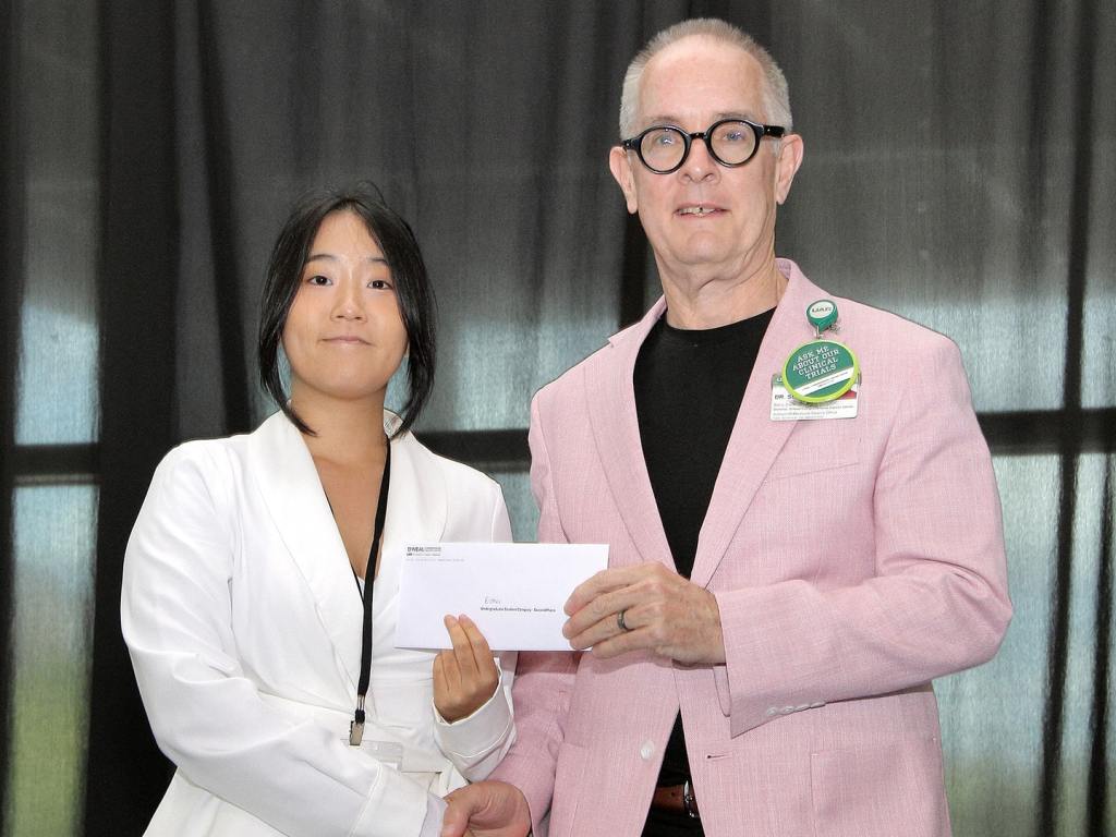 Esther Lee receives an award at the 2026 O'Neal Research Retreat.