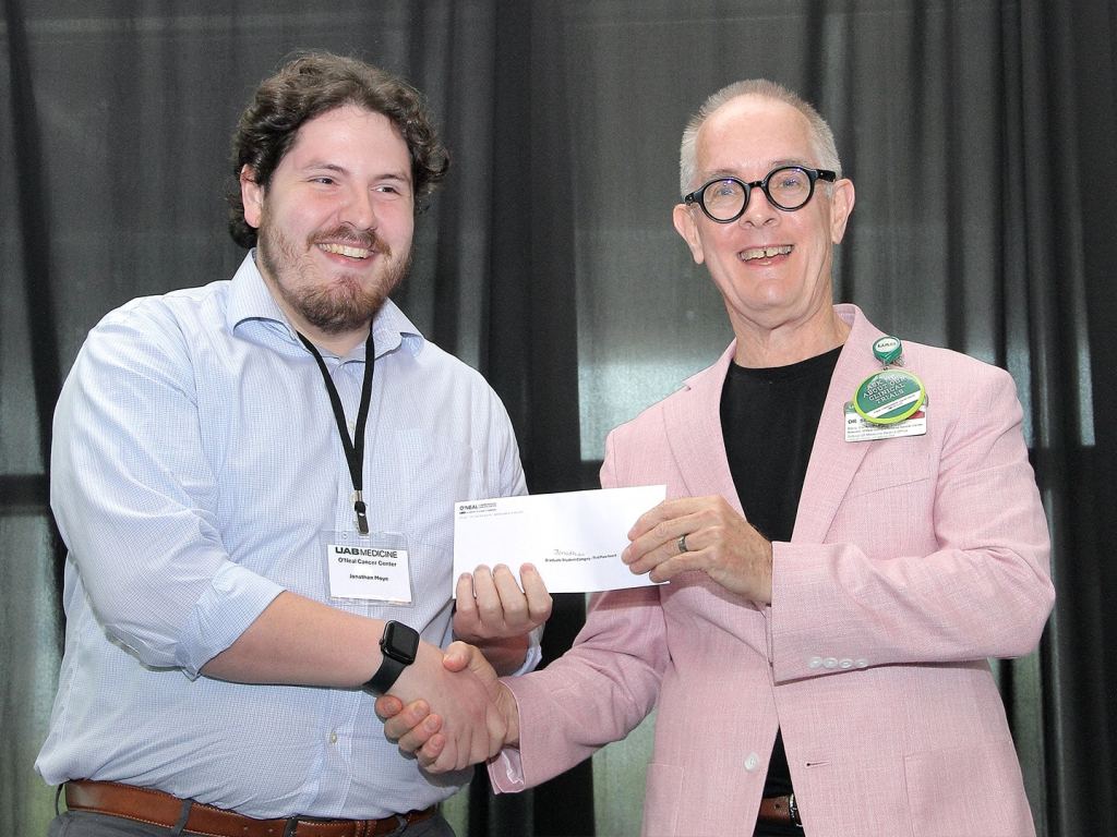 Jonathan Moye receives an award at the 2026 O'Neal Research Retreat.