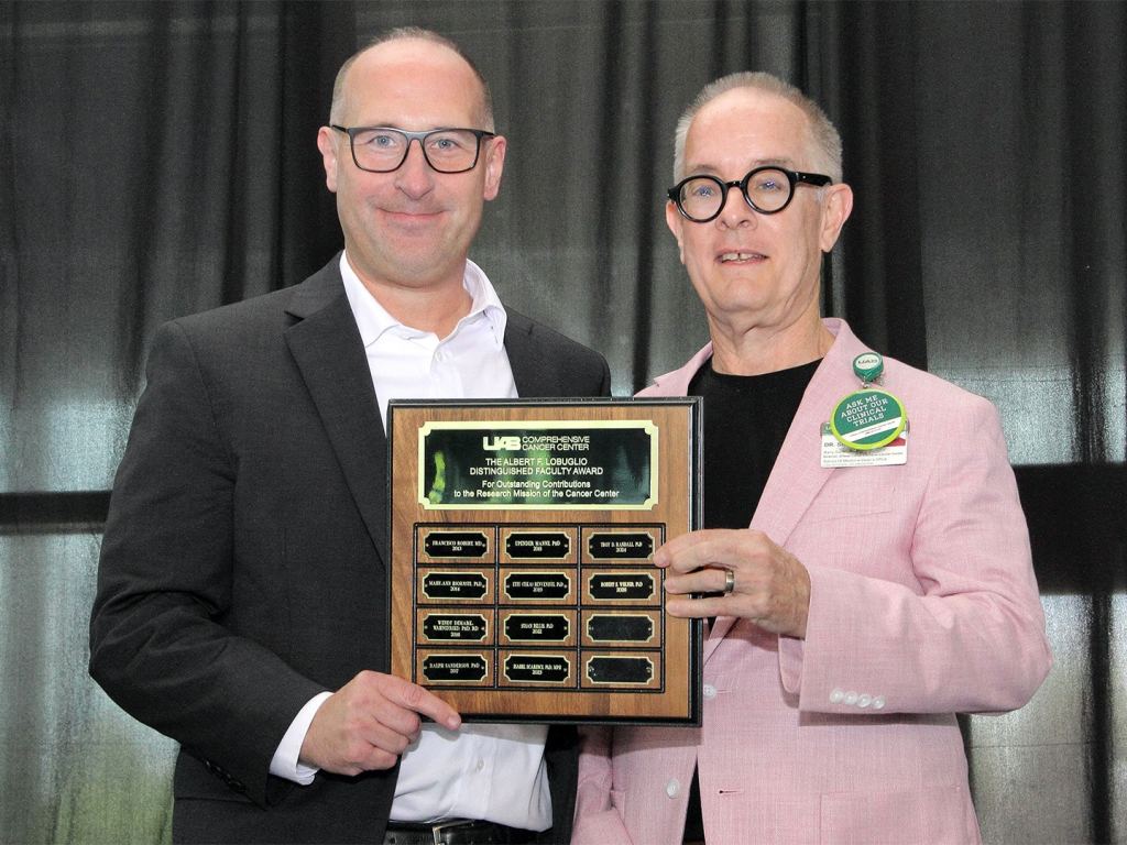 Robert Welner, Ph.D., receives an award at the 2026 O'Neal Research Retreat.