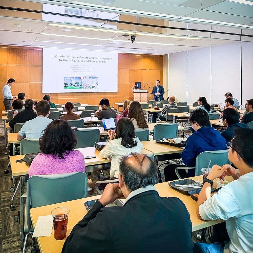 An audience listens to Zhipeng Meng, Ph.D. deliver a seminar.