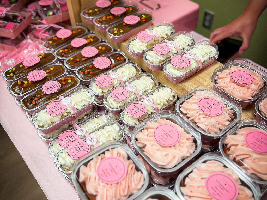 Various baked goods in plastic containers at the 2026 Pink Party.